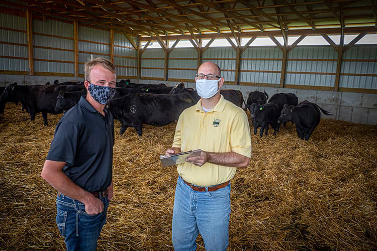 Ethan Whiteside (left) working with USDA on his operation.