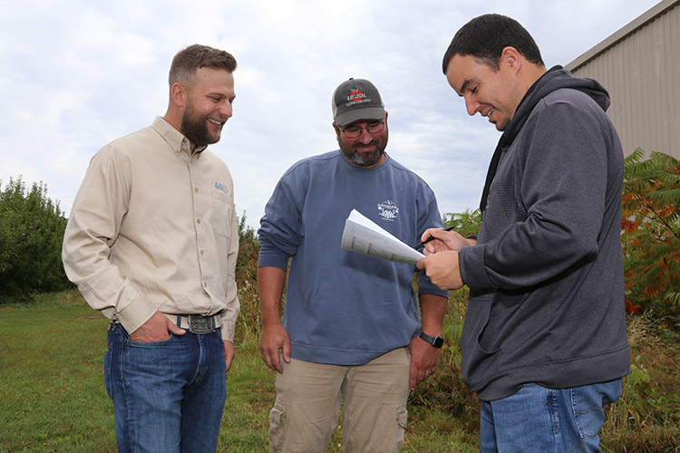 Mike with Robert Purcell, NRCS soil conservationist, and Manuel Diaz Gonzales, NRCS engineer, on the farm in October 2019.