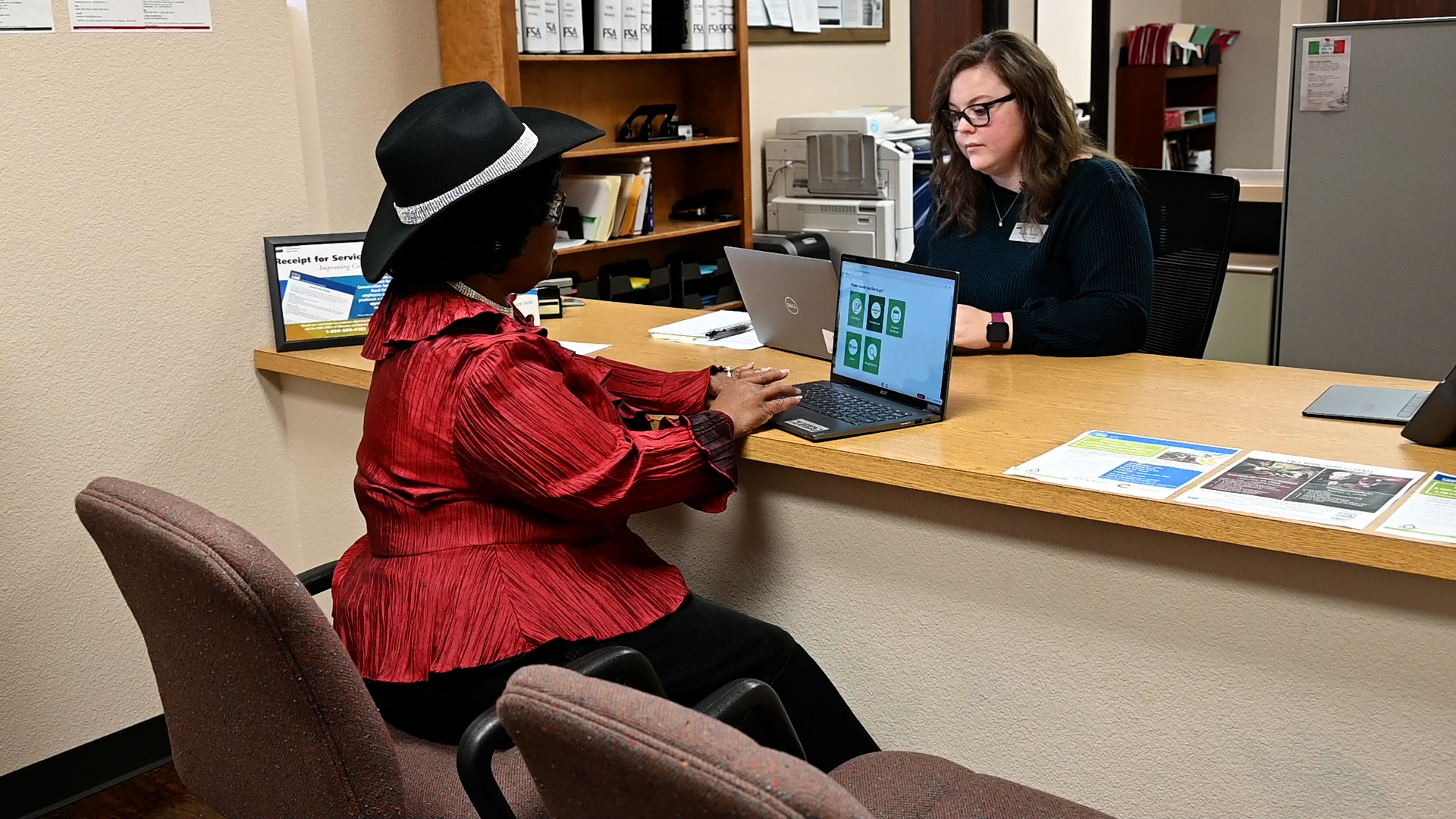 Two people sitting across from each other at a desk