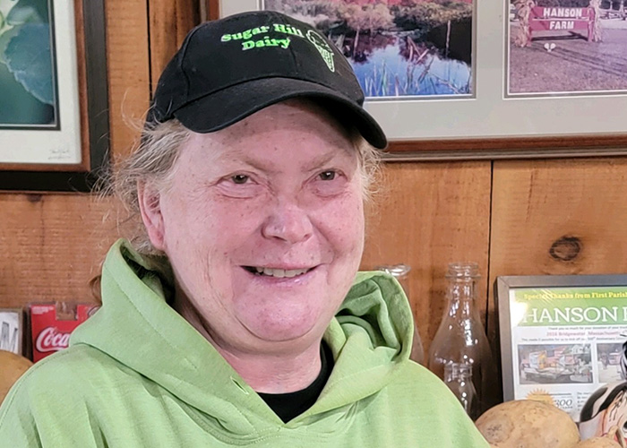 Person in black hat smiling