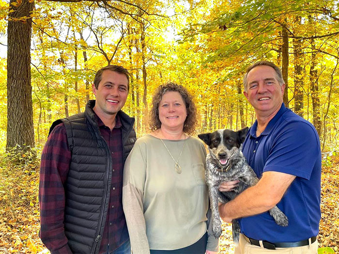Three people and a dog