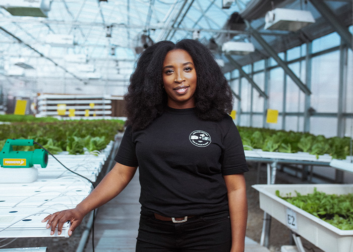 Person standing in a greenhouse