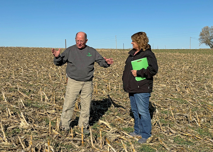 Two people in a field of stalks