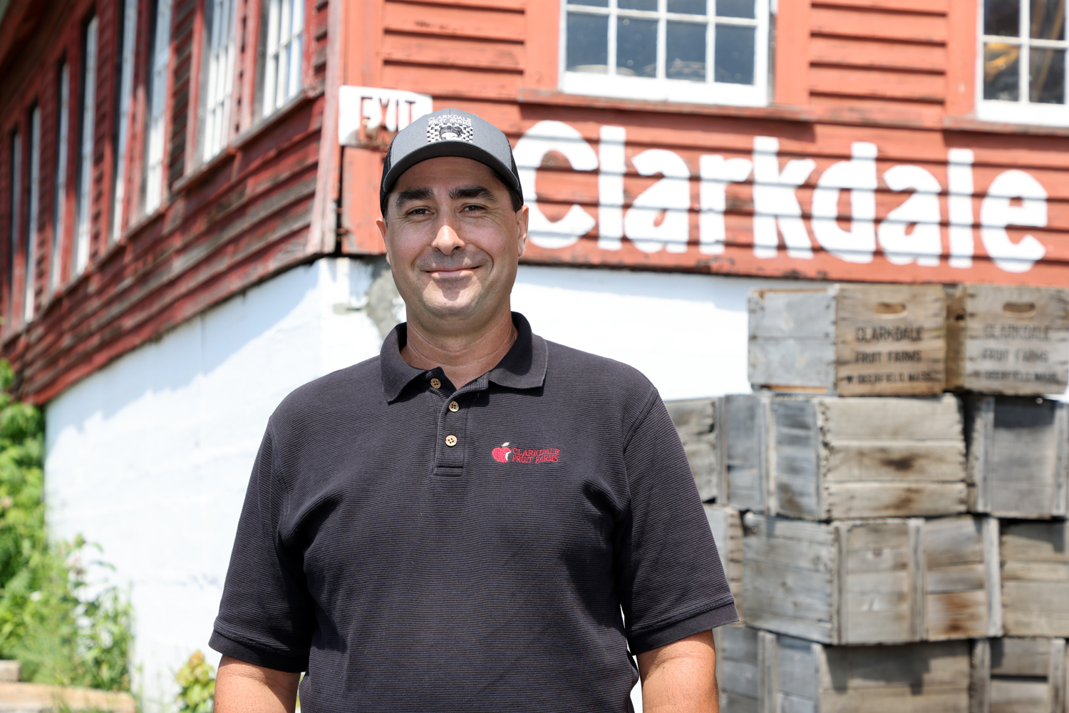 Person standing in front of a farmhouse