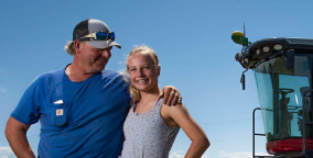 Two farmers with blue sky behind them