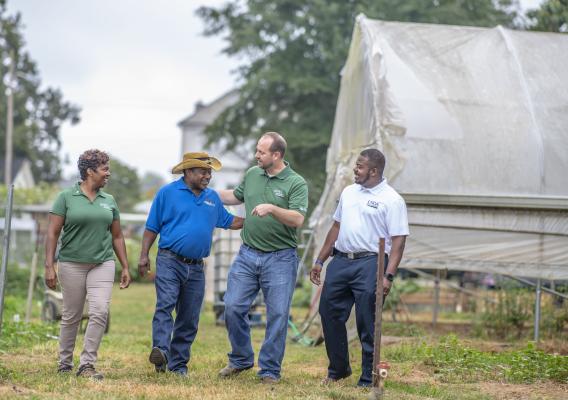 Metro Atlanta Urban Farm CEO Bobby Wilson talks with NRCS District Conservationist Shemekia Mosley, NRCS State Public Affairs Specialist Chris Groskreutz and FSA Beginning Farmer Regional Coordinator Rodney Brooks about future opportunities his farm.  USDA photo by Preston Keres.