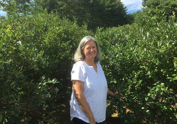 Ingrid Fratantuono, Agricultural Program Specialist for the USDA Farm Service Agency (FSA) State Office in Rhode Island, stands in a plant nursery field.