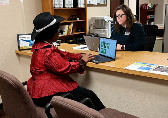 Two people sitting across from each other at a desk