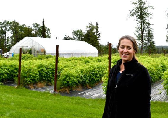 Person standing in front of garden