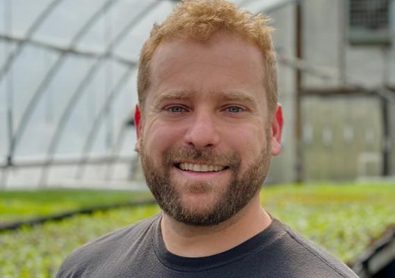 Person standing in greenhouse